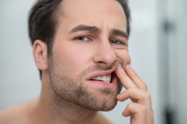  A man experiencing cotton mouth symptoms due to Medical Marijuana. 